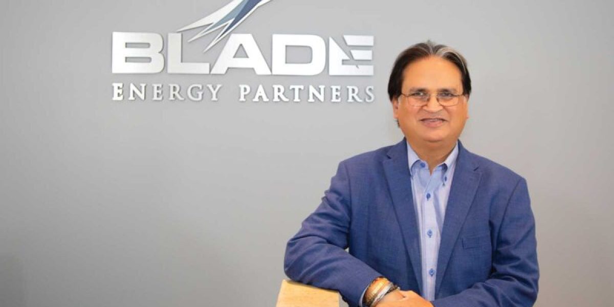 Suri standing in front of Blade Energy Partners sign